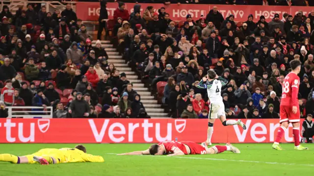 Dan Neil celebrates his goal with Middlesbrough's George Edmundson and Mark Travers lying on the pitch