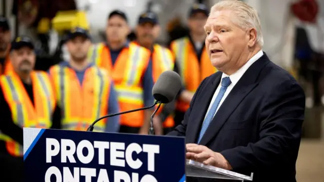 Ontario Premier Doug Ford stands in front of a podium that reads: Protect Ontario