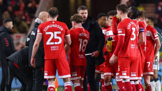 Middlesbrough manager Michael Carrick delivers a hastily-arranged team talk on the touchline during a break in play