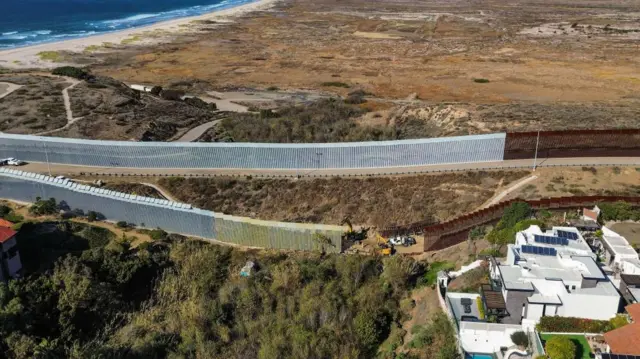 An aerial photo shows the US-Mexico border wall near Tijuana.