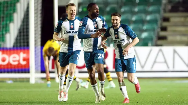 Gwion Edwards of Morecambe celebrates scoring a goal