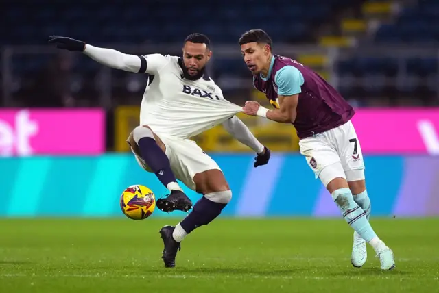 Oxford United's Matt Phillips (left) and Burnley's Jeremy Sarmiento battle for the ball