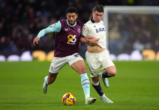 Burnley's Josh Laurent (left) and Oxford United's Cameron Brannagan battle for the ball