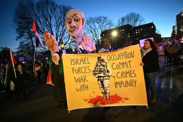 Protesters rally against Israeli Prime Minister Benjamin Netanyahu near the White House in Washington DC, where he is meeting US President Donald Trump