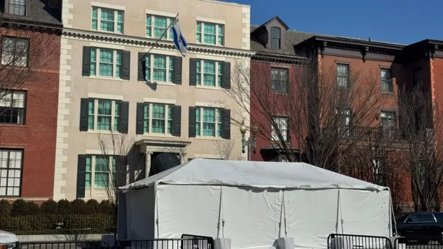 A white tent in front of the main door