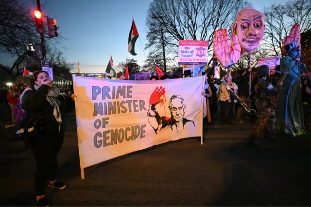 Protesters rally against Israeli Prime Minister Benjamin Netanyahu near the White House in Washington DC, where he is meeting US President Donald Trump