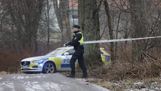 Police forces cordon off the scene of the shooting at Risbergska School in Orebro, Sweden