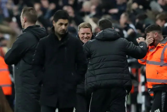 Howe celebrates with Tindall in the background as Arteta shakes his head in the foreground