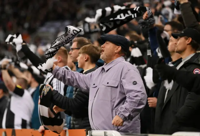 Newcastle fans wave flags in the stands