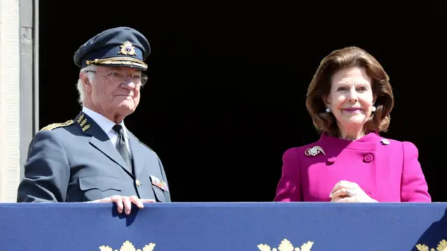 Carl XVI Gustaf, King of Sweden and Queen Silvia of Sweden stand on a balcony (file photo)