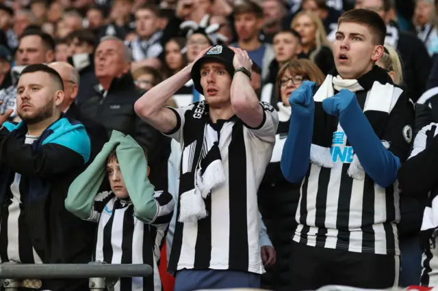 Newcastle fans react to a Manchester United goal at Wembley