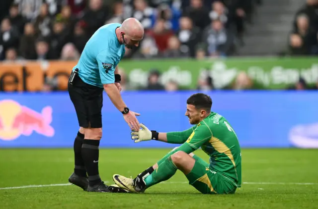 Dubravka is given a helping hand by the referee