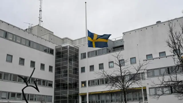 A flag flutters at half-mast outside Orebro police station