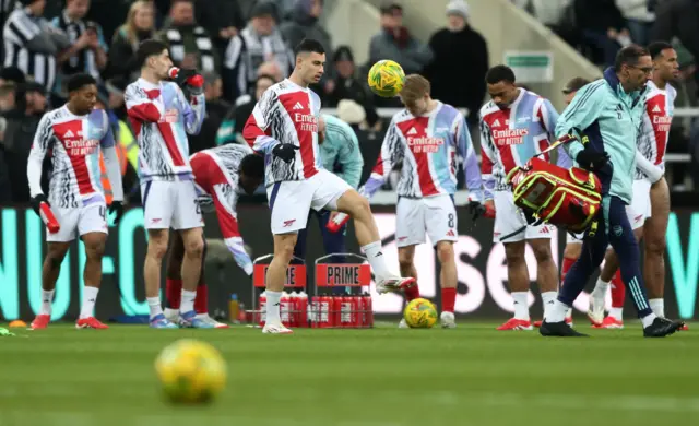 Arsenal players warm up at St James' Park