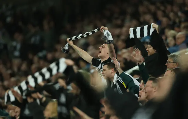 Fans sing and hold scarves alott in the Newcastle home end