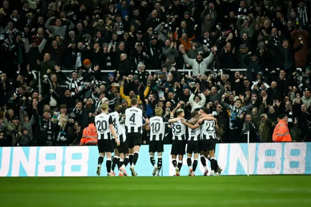 Newcastle players celebrate with their fans after Murphy's goal