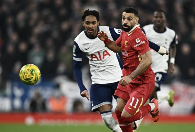 Liverpool's Mohamed Salah in action with Tottenham Hotspur's Djed Spence