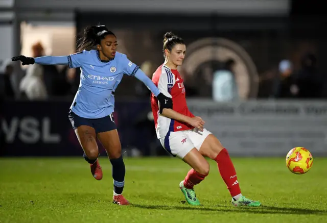 Emily Fox of Arsenal passes the ball whilst under pressure from Kerolin Nicoli