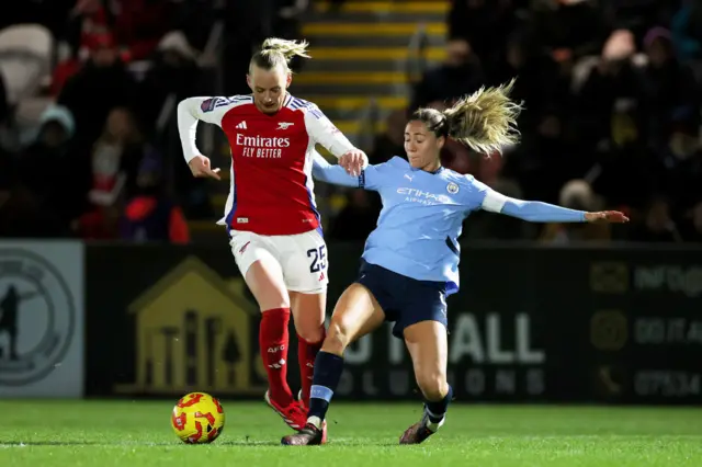 Stina Blackstenius of Arsenal is challenged by Laia Aleixandri