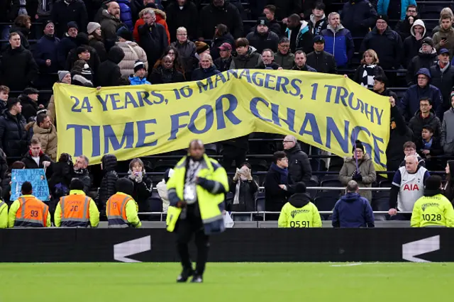 Fans of Tottenham Hotspur hold up a banner in protest