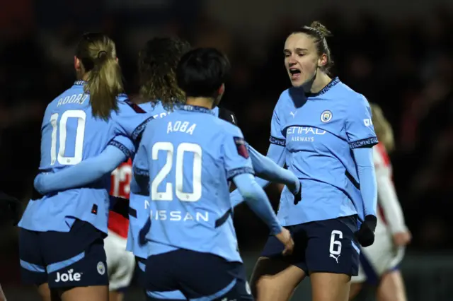 Mary Fowler of Manchester City (obscured) celebrates with teammates Jill Roord, Aoba Fujino and Vivianne Miedema