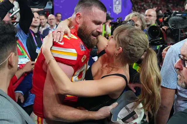 Alt text: Travis Kelce hugs Taylor Swift at last year’s Super Bowl following his victory.