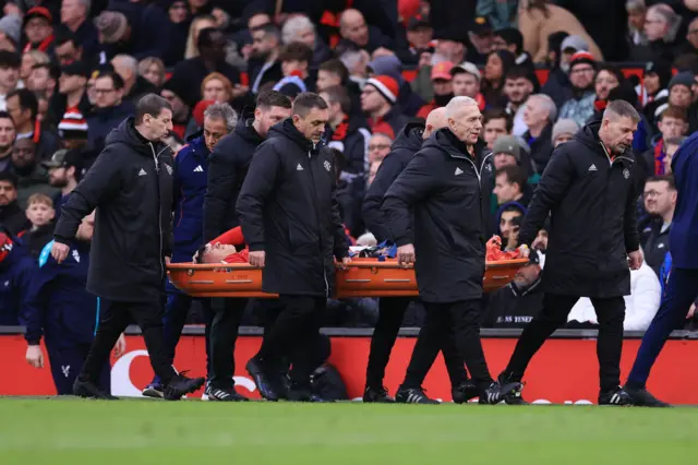 Lisandro Martinez of Manchester United is stretchered off the pitch with an injury.