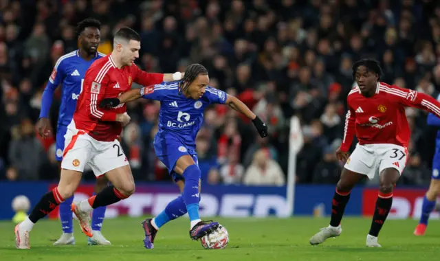 Diogo Dalot of Manchester United and Bobby Decordova-Reid of Leicester City challenge.