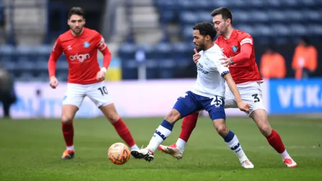 Duane Holmes of Preston North End is challenged by Daniel Harvie of Wycombe Wanderers