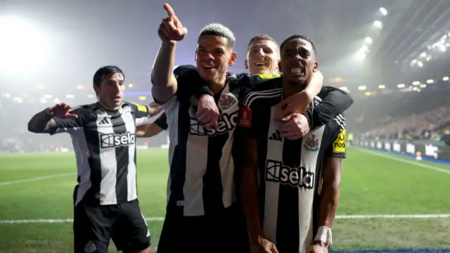 Joe Willock of Newcastle United celebrates scoring his team's third goal with teammates