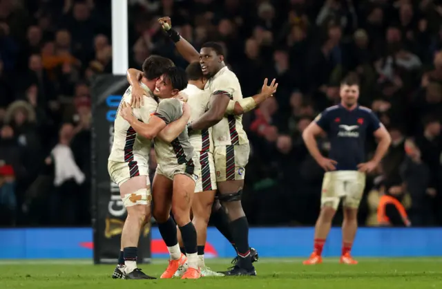 Ben Curry and Marcus Smith hugging after the win to France