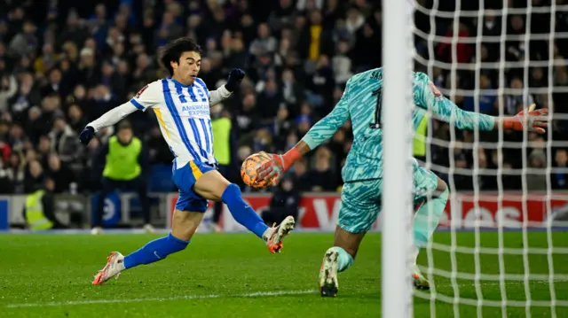 Brighton & Hove Albion's Kaoru Mitoma scores their second goal past Chelsea's Robert Sanchez