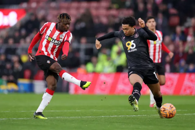 Kamaldeen Sulemana of Southampton shoots whilst under pressure from Bashir Humphreys of Burnley