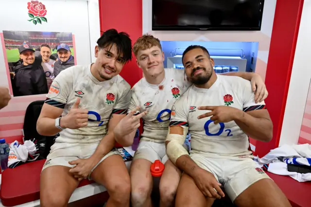 Marcus Smith, Fin Smith and Ollie Lawrence all posing for a photo in the dressing room