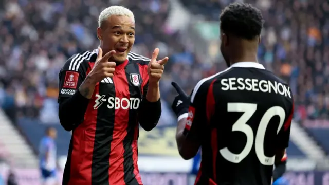 Rodrigo Muniz of Fulham celebrates scoring his team's first goal with teammate Ryan Sessegnon