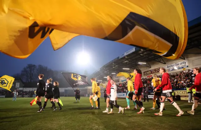 Players walk onto pitch