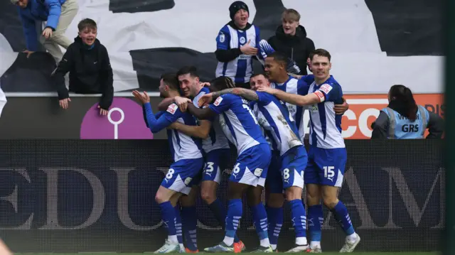 Wigan Athletic's Jonny Smith celebrates scoring their first goal with teammates