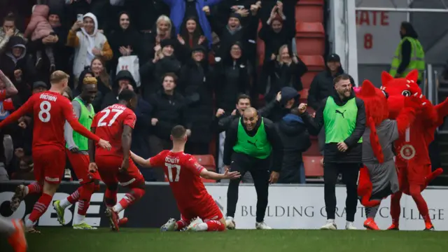 Leyton Orient's Jamie Donley and teammates celebrate their first goal an own goal scored by Manchester City's Stefan Ortega