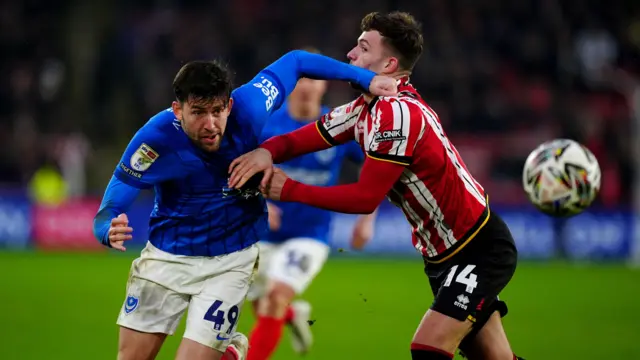 Portsmouth's Callum Lang breaks past Sheffield United's Harrison Burrows