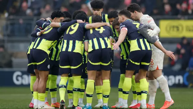 Manchester City players huddle before the match