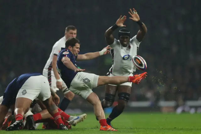 Dupont box kicking and Itoje reaching to stop the flying ball