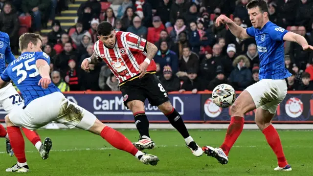 Gus Hamer curls his shot into the far corner of the Portsmouth net