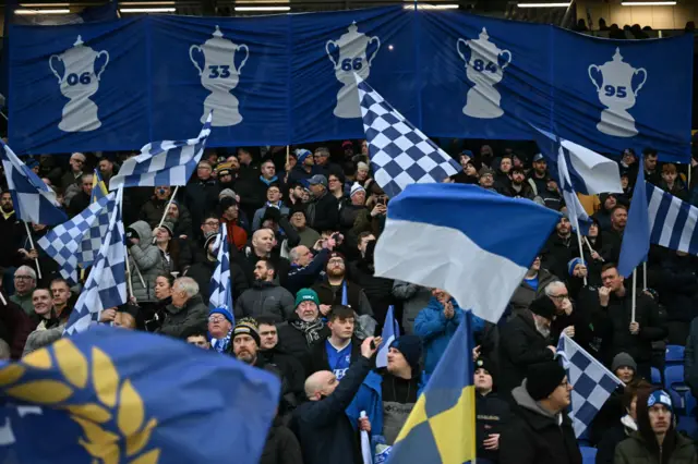 Everton fans display their FA Cup wins on a banner at the back of the stand