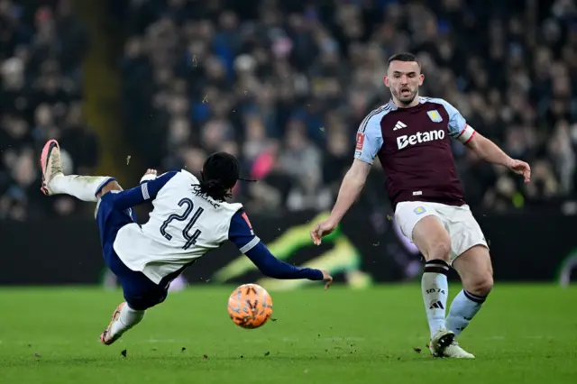 Djed Spence of Tottenham Hotspur goes down after a challenge on John McGinn