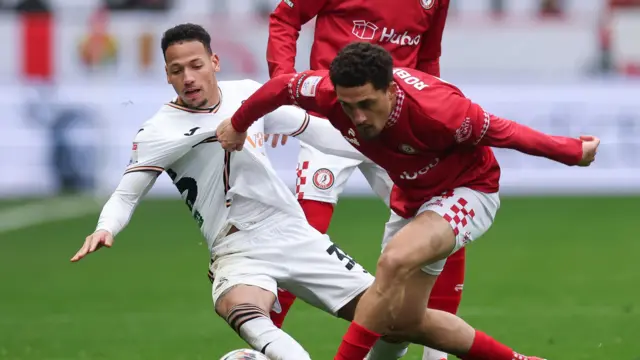 Ronald of Swansea City takes on Anis Mehmeti of Bristol City and Haydon Roberts of Bristol City