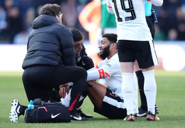 Liverpool's Joe Gomez is treated for an injury before leaving the game