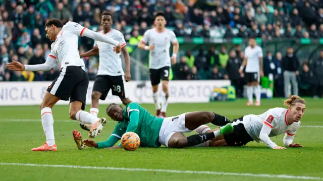 Plymouth Argyle's Mustapha Bundu in action with Liverpool's Kostas Tsimikas