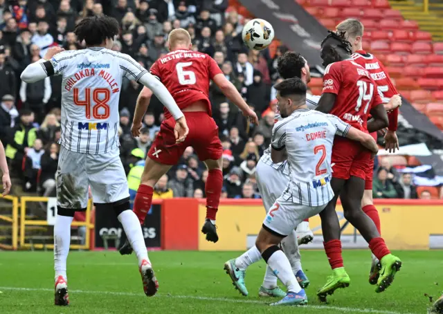 Papa Gueye powers a header in