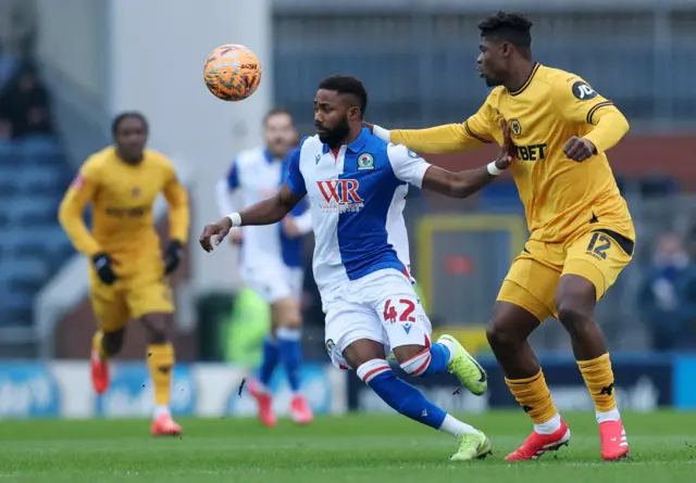 Blackburn Rovers' Emmanuel Dennis in action with Wolverhampton Wanderers' Emmanuel Agbadou