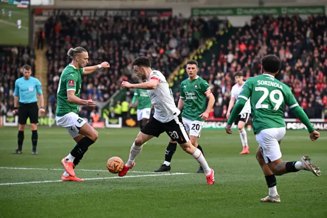 Diogo Jota of Liverpool is challenged by Maksym Talovierov